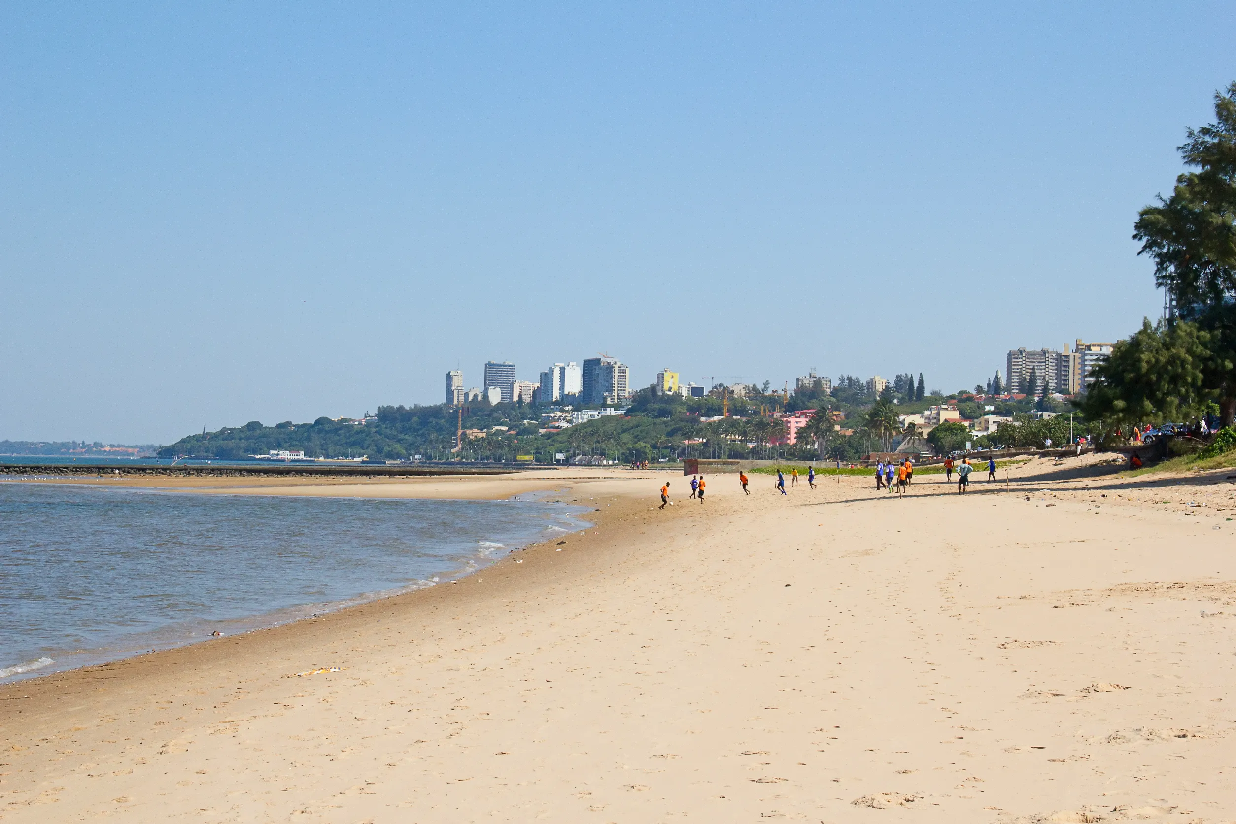people playing soccer on the beach in maputo mozambique