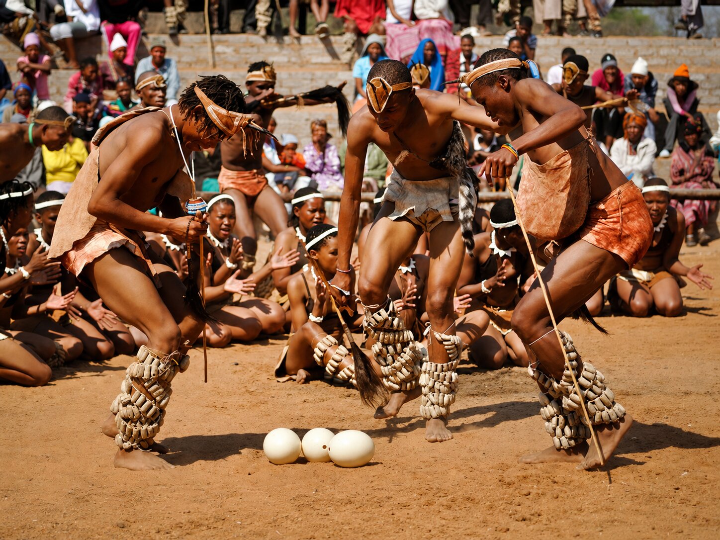 Performers dancing around a few eggs in Botswana