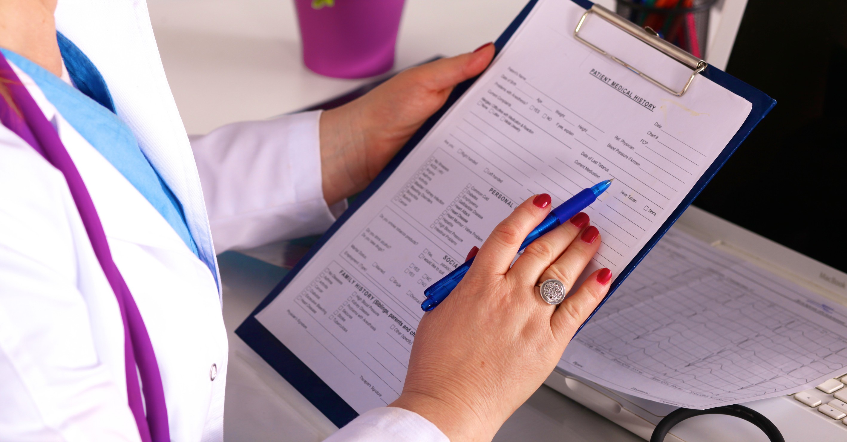 Young Girl Doctor Sits At A Desk In The Office